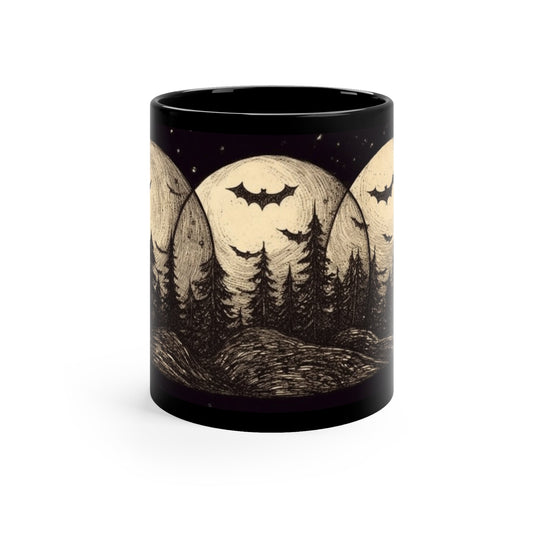 The front view of an alternative fashion black coffee mug with an image of bats flying in a forest at night in front of three moons.