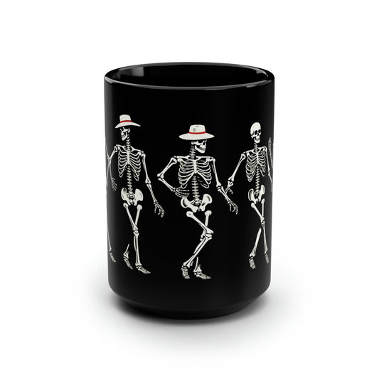 A front view of a black coffee mug with an image of dancing skeletons in hats printed on it.