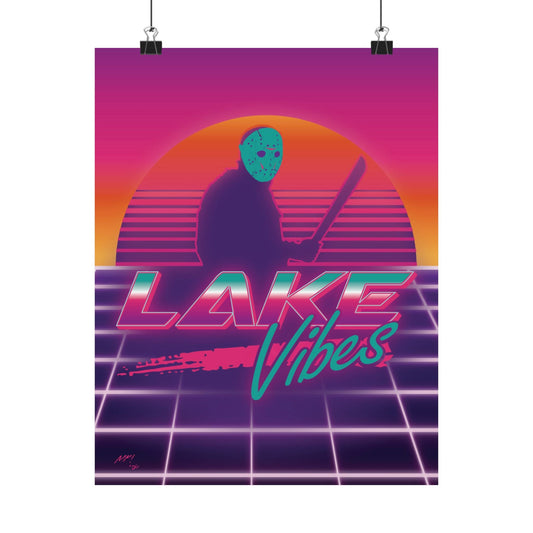 A poster hanging from two clips featuring an orange sunset and Jason Vorhees in front of it in silhouette and the words "Lake Vibes" underneath in a retro 80s style on pink/orange/purple gradated background with lines by Glow Bat Horror Designs