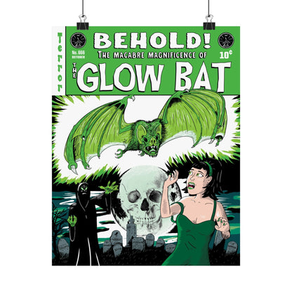A poster hanging from clips on a white background featuring an original green, white, and black illustration by Glow Bat Horror Designs of a dark figure summoning a large green bat towards an attractive dark-haired woman in a green dress. They are in a cemetery with a full moon with a skull in it. It is designed to look like an old horror comic like Tales From the Crypt.