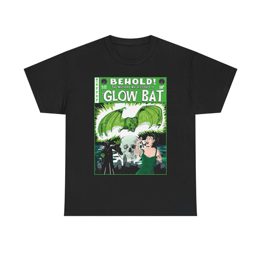 A black t-shirt on a white background featuring an original green, white, and black illustration by Glow Bat Alternative Fashion of a dark figure summoning a large green bat towards an attractive dark-haired woman in a green dress. They are in a cemetery with a full moon with a skull in it. It is designed to look like an old horror comic like Tales From the Crypt.